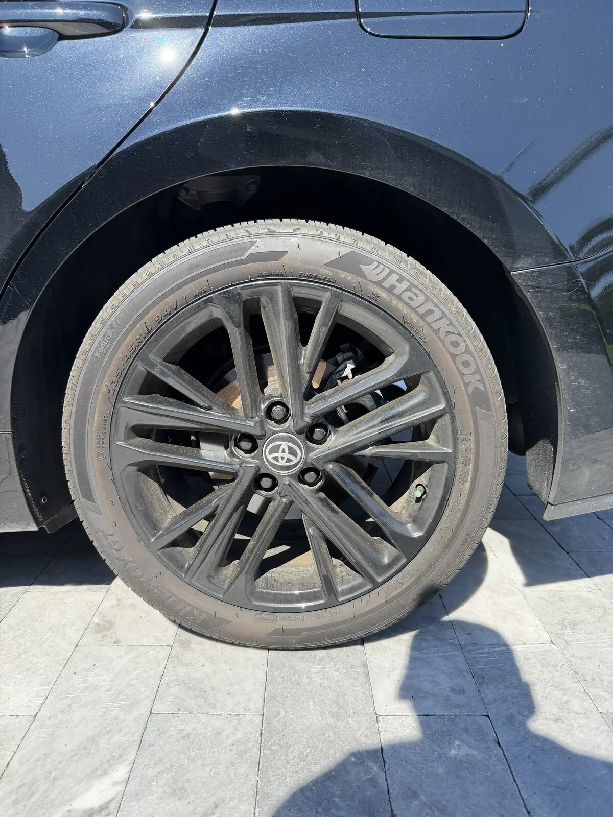 Black Toyota Camry wheel detail — before